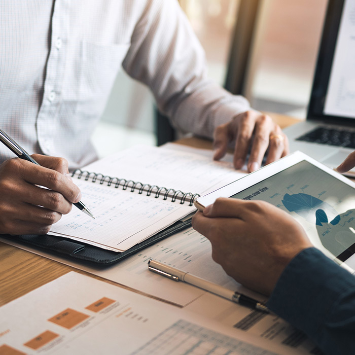 two men discussing a financial planning graph