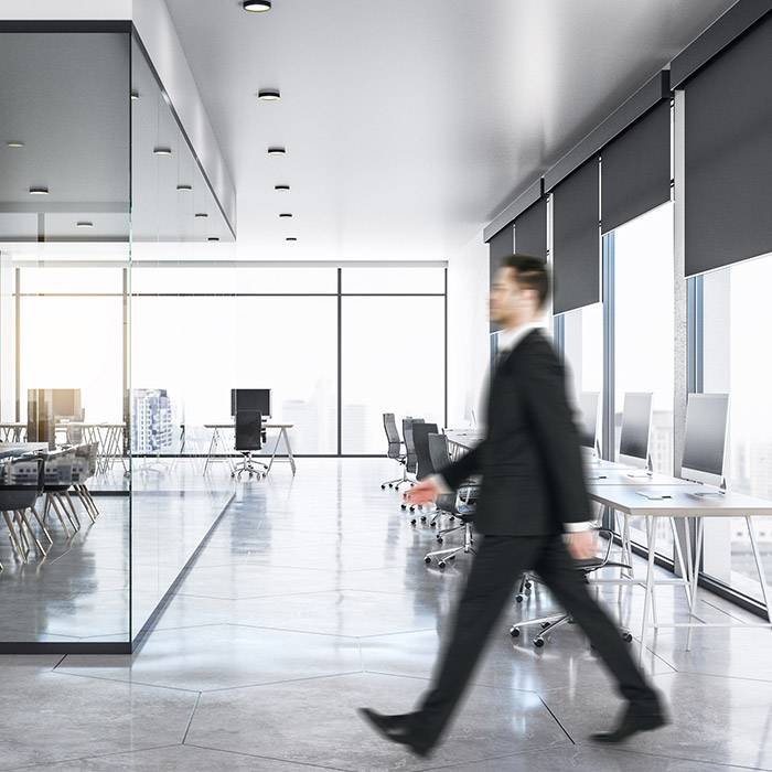 young businessman in clean glass concrete office